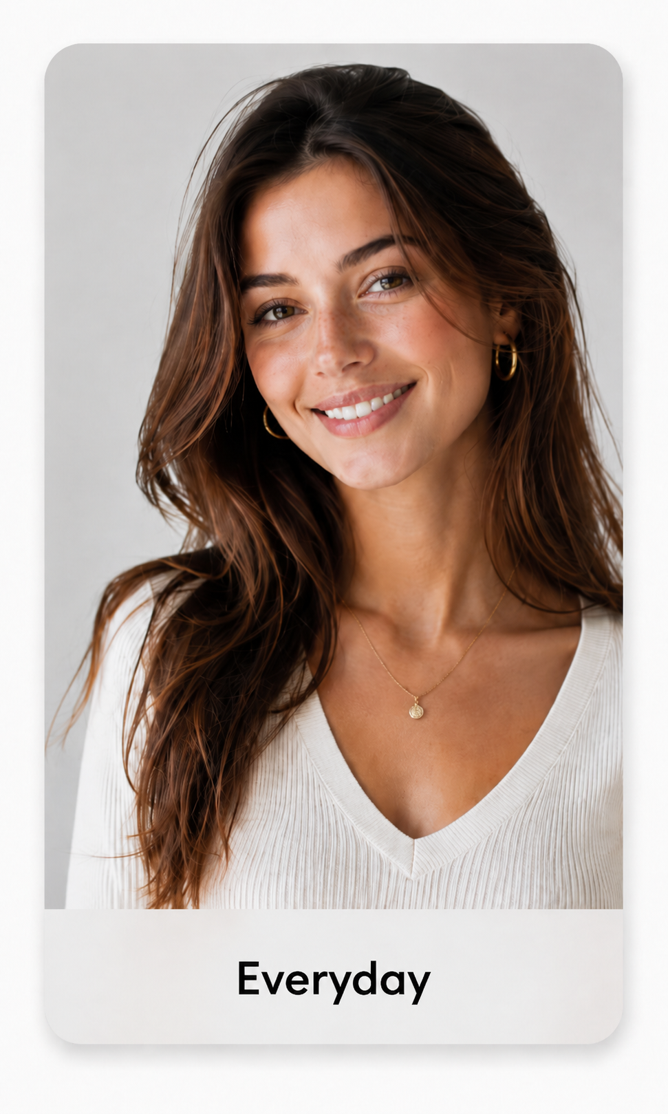 Everyday look: woman with long wavy hair in a white knit top, portrait