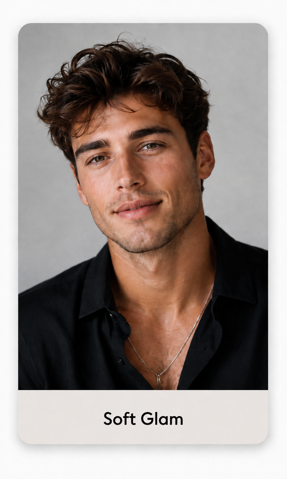 Soft glam look: man with textured curls in an open black shirt, portrait